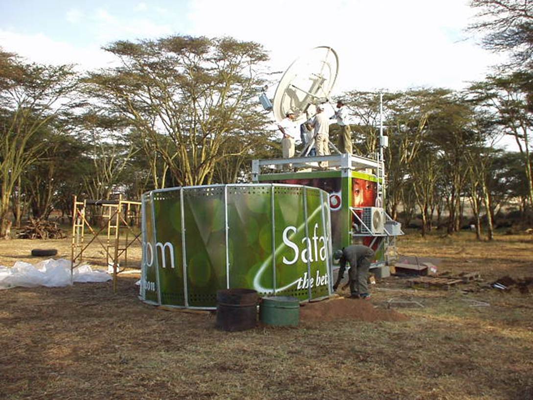 A green structure with a satellite dish

Description automatically generated